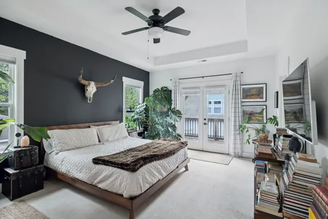 a bedroom with a bed couch and a window