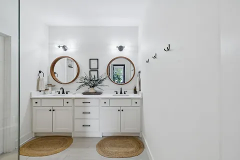 a bathroom with a toilet a sink and a mirror