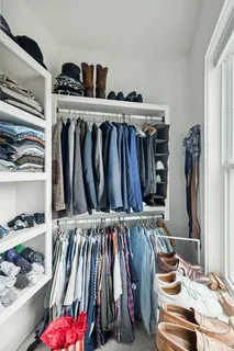 a view of walk in closet with clothes and shoes