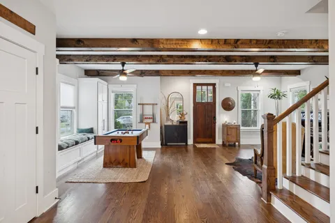 a view of living room with furniture and wooden floor