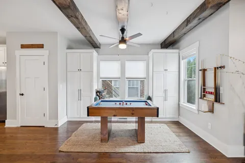 a living room with furniture a table and a potted plant