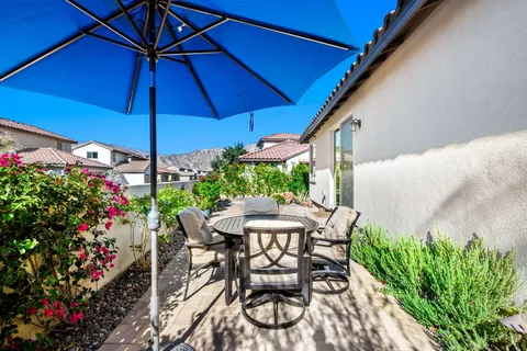 a view of a patio with furniture and a umbrella