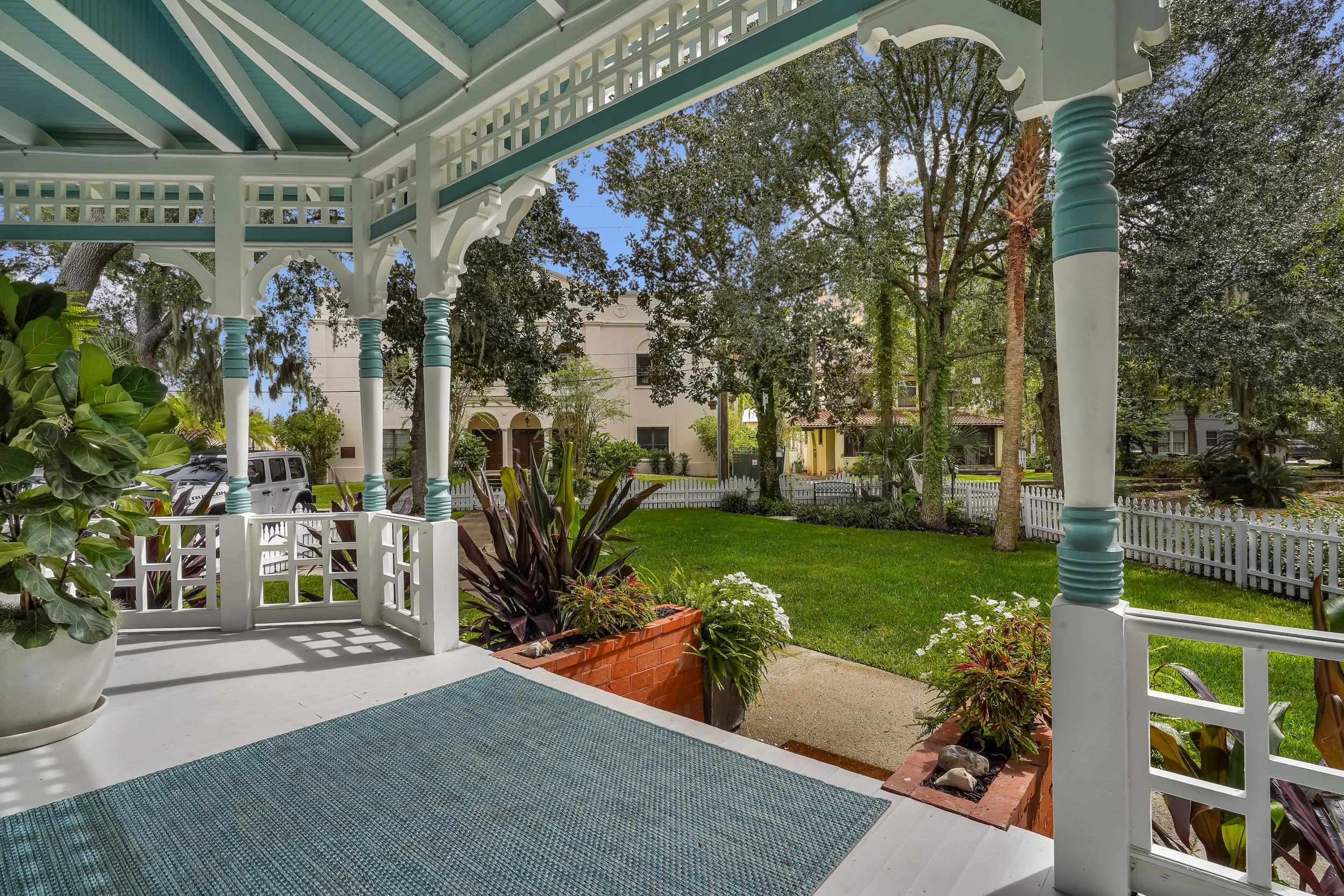 268 St George Street St. Augustine, FL 32084 - Photo 11 of 71 a view of a porch with couches and table and chairs and potted plants