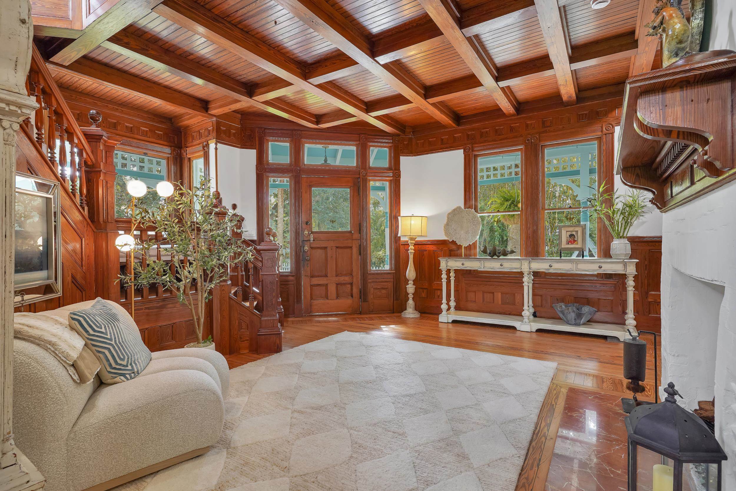 268 St George Street St. Augustine, FL 32084 - Photo 12 of 71 Entrance foyer with a wooden ceiling with exposed beams, wooden walls, healthy amount of natural light, and wood finished floors