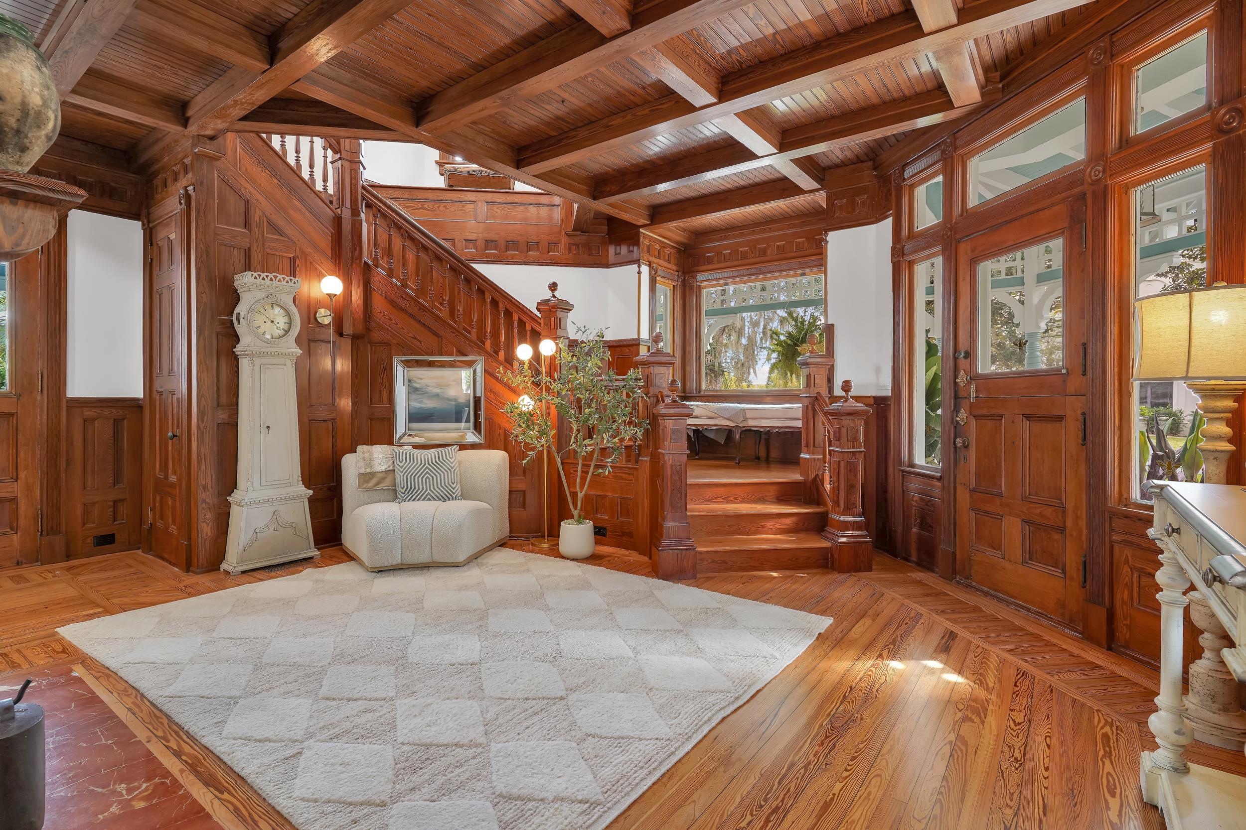 268 St George Street St. Augustine, FL 32084 - Photo 22 of 71 Entrance foyer featuring stairway, wooden walls, a wood ceiling with exposed beams, light wood-style floors, and coffered ceiling