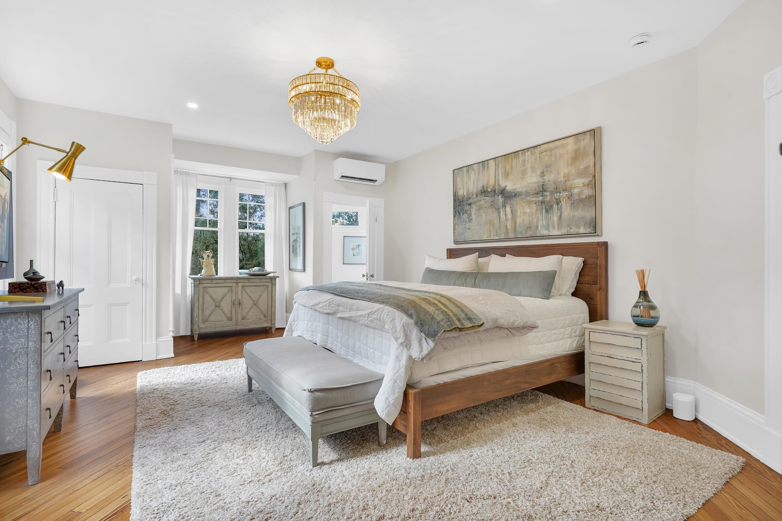 268 St George Street St. Augustine, FL 32084 - Photo 25 of 71 Bedroom with light wood-style flooring, a chandelier, a wall unit AC, and recessed lighting