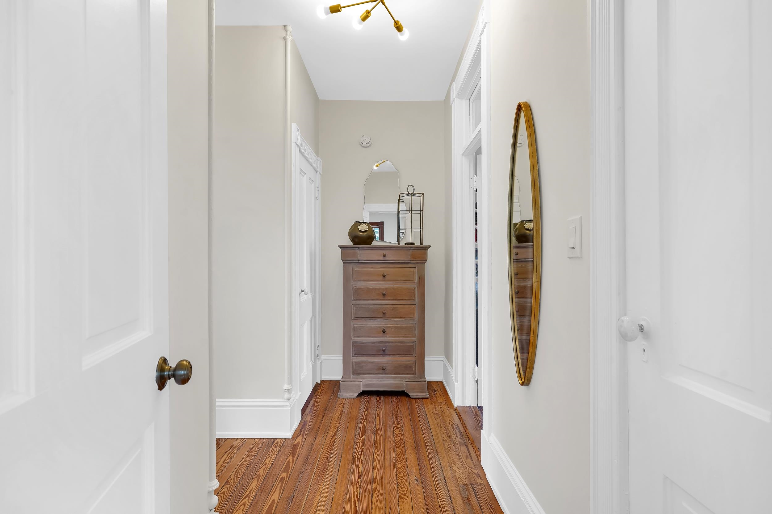 268 St George Street St. Augustine, FL 32084 - Photo 31 of 71 Hallway featuring wood finished floors and baseboards