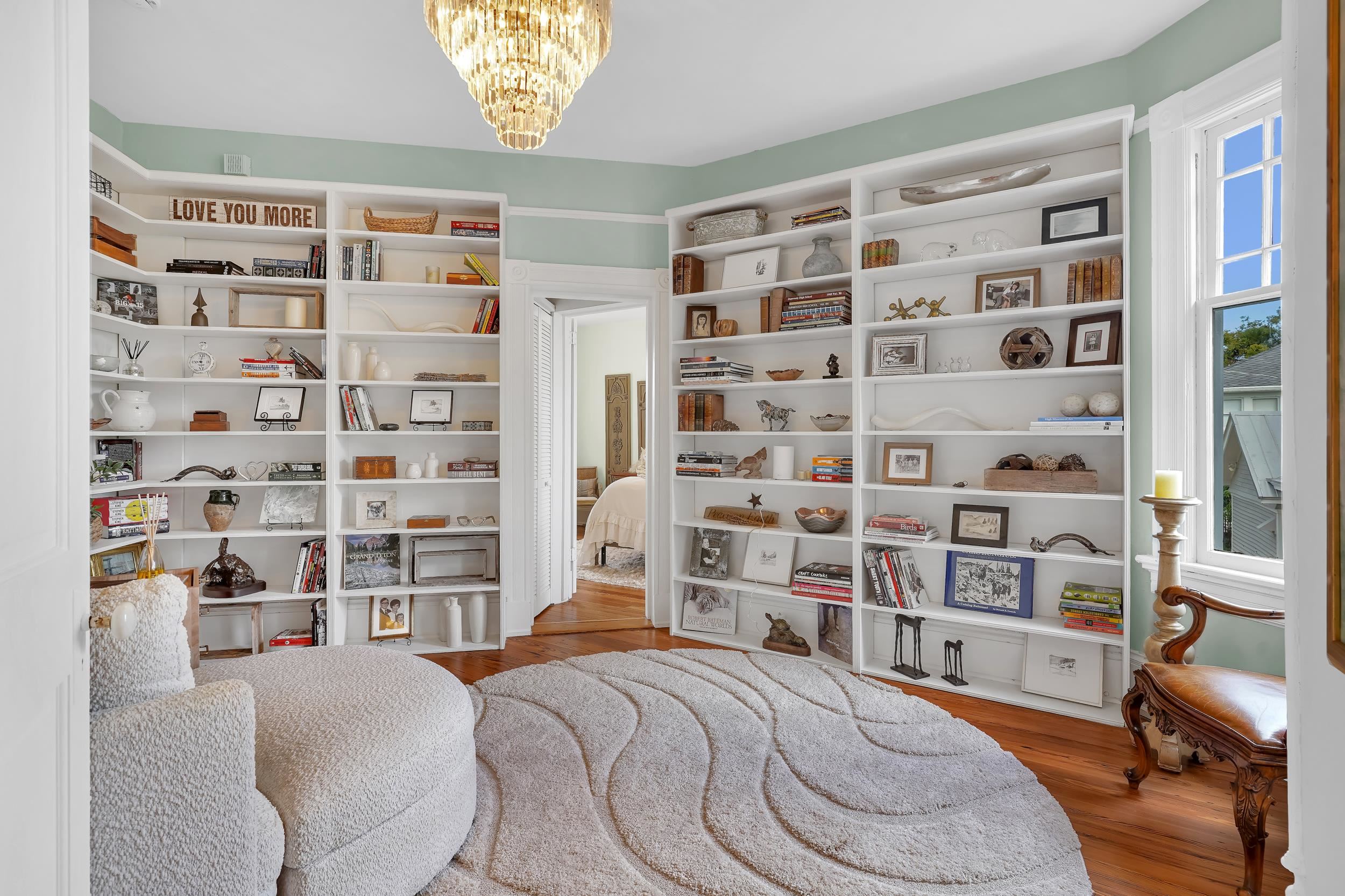 268 St George Street St. Augustine, FL 32084 - Photo 32 of 71 a bedroom with a bed and a bookshelf