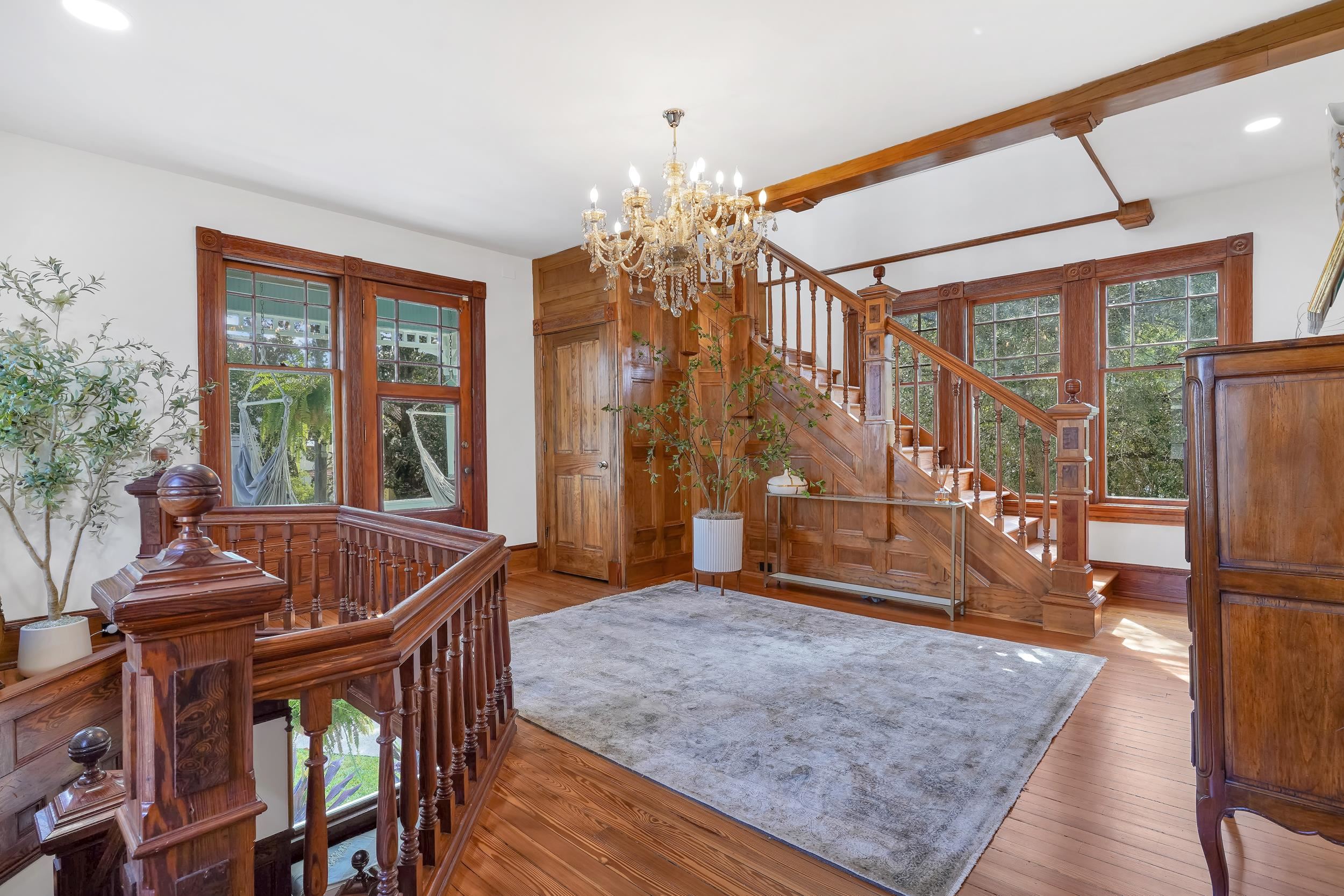 268 St George Street St. Augustine, FL 32084 - Photo 39 of 71 a living room with furniture and a chandelier