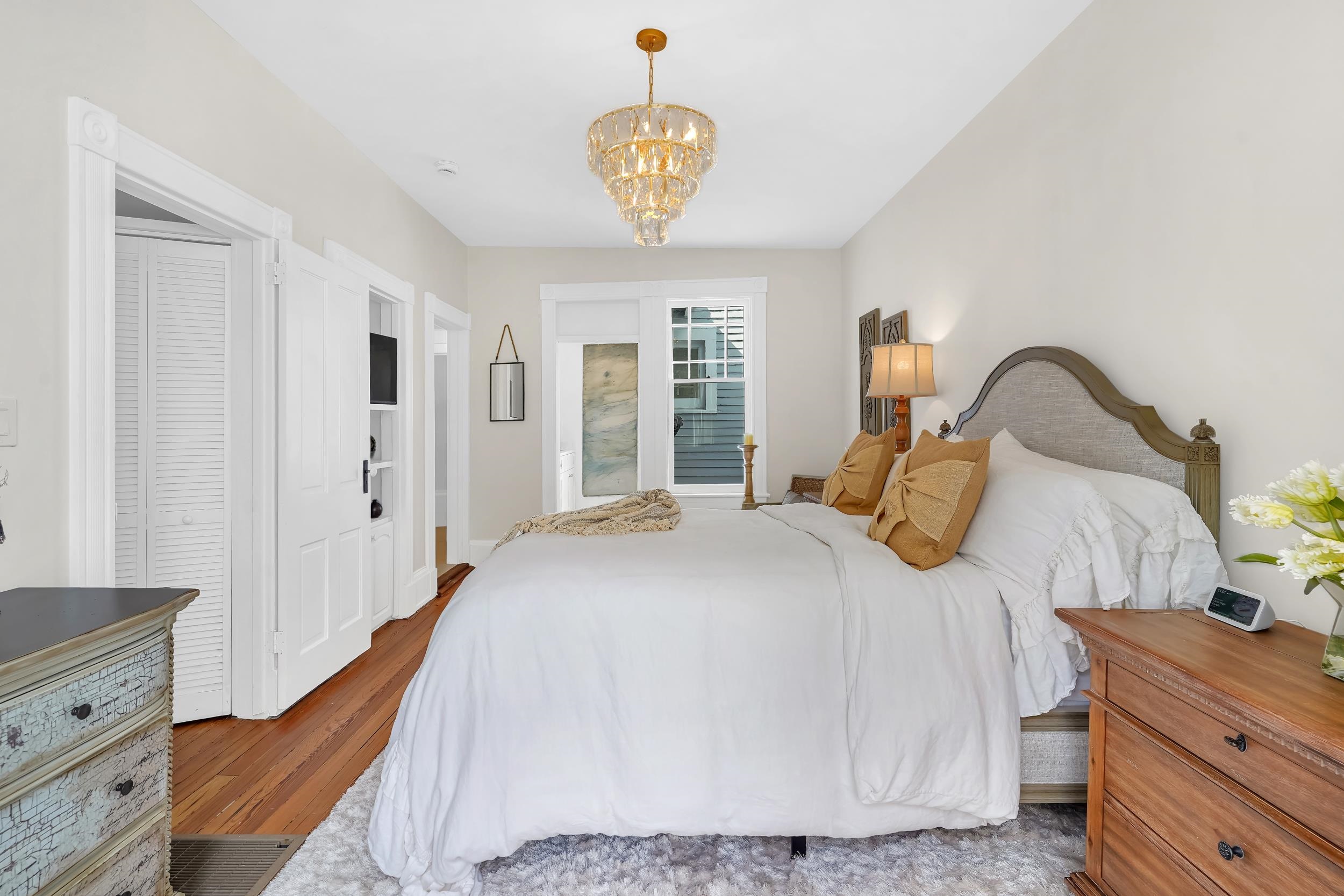 268 St George Street St. Augustine, FL 32084 - Photo 40 of 71 Bedroom featuring wood finished floors and a chandelier