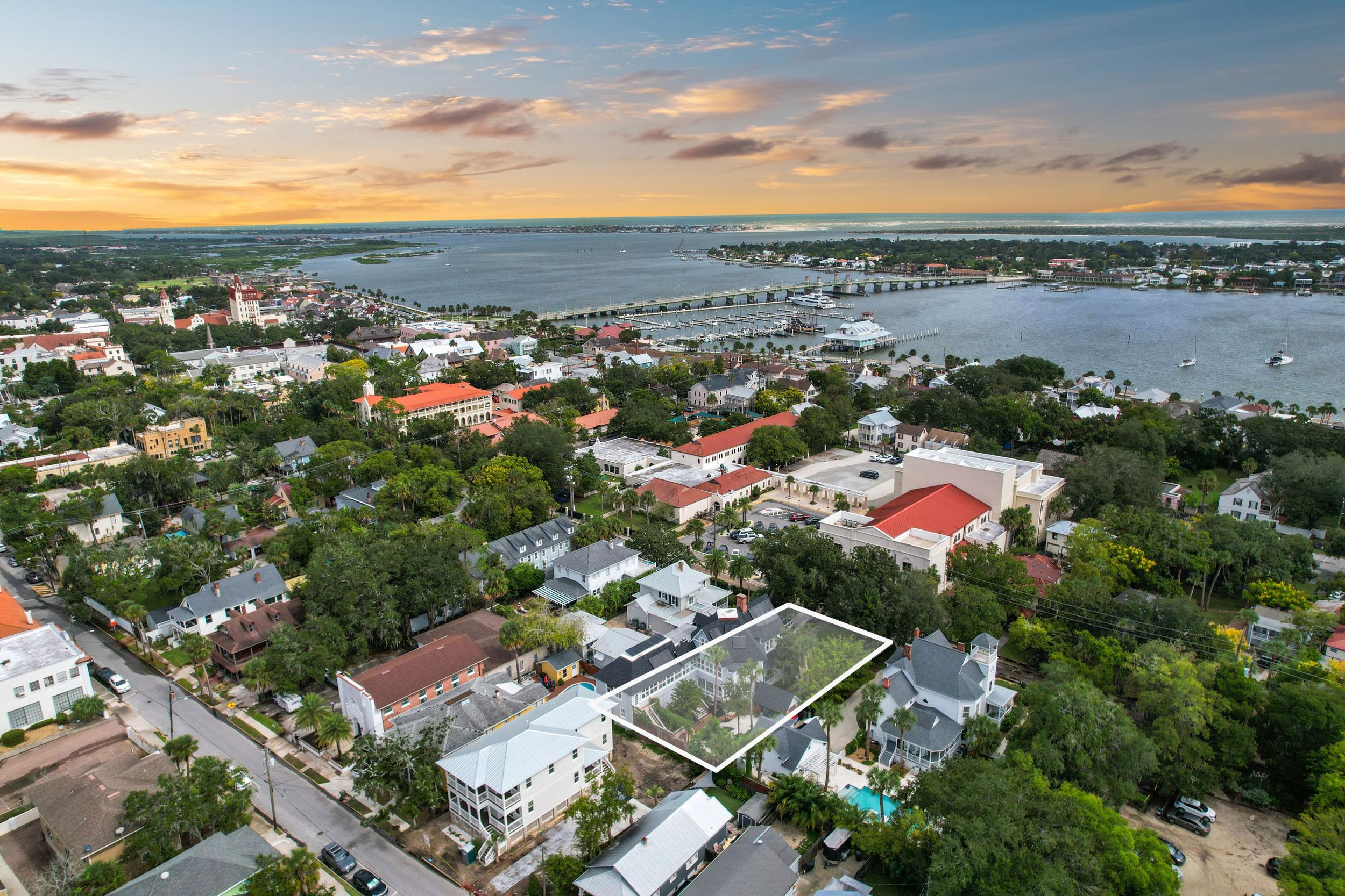 268 St George Street St. Augustine, FL 32084 - Photo 4 of 71 Aerial view of property's location with a notable bridge, property parcel outlined, and nearby suburban area