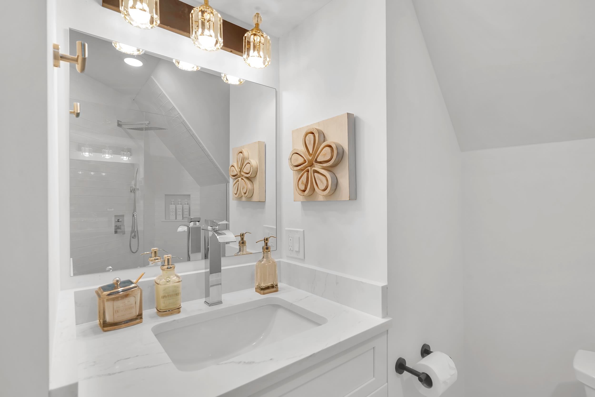 268 St George Street St. Augustine, FL 32084 - Photo 45 of 71 a bathroom with a sink a mirror and a shower