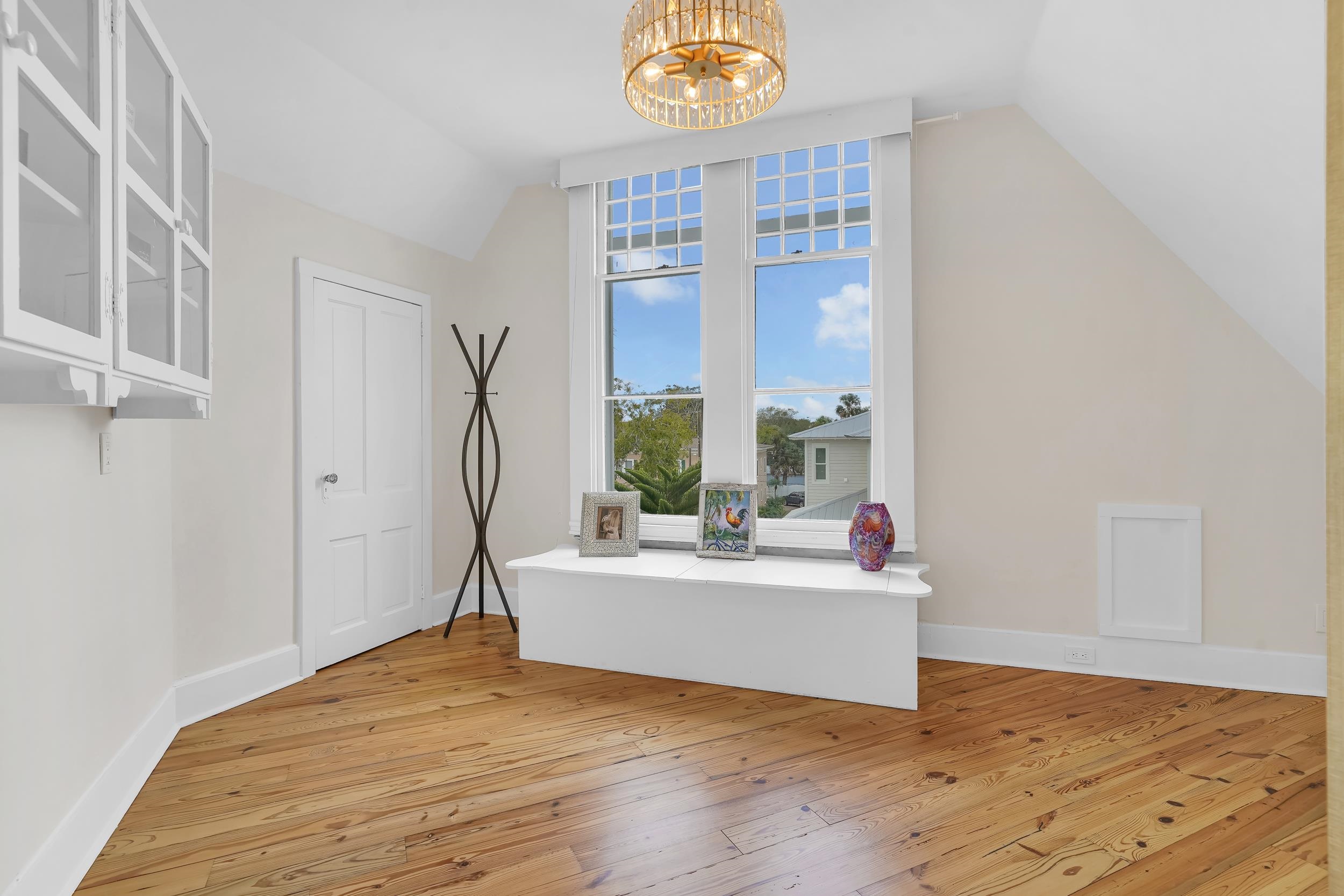 268 St George Street St. Augustine, FL 32084 - Photo 46 of 71 a view of an empty room with wooden floor and a window
