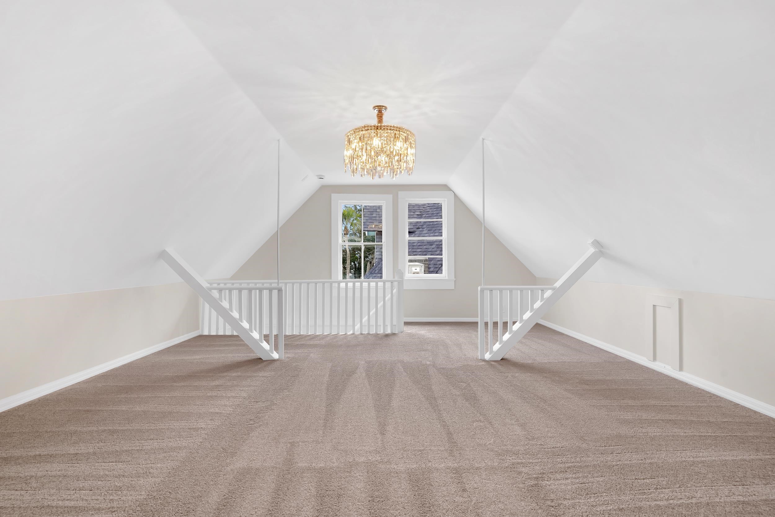 268 St George Street St. Augustine, FL 32084 - Photo 59 of 71 Additional living space with carpet floors, lofted ceiling, and a chandelier