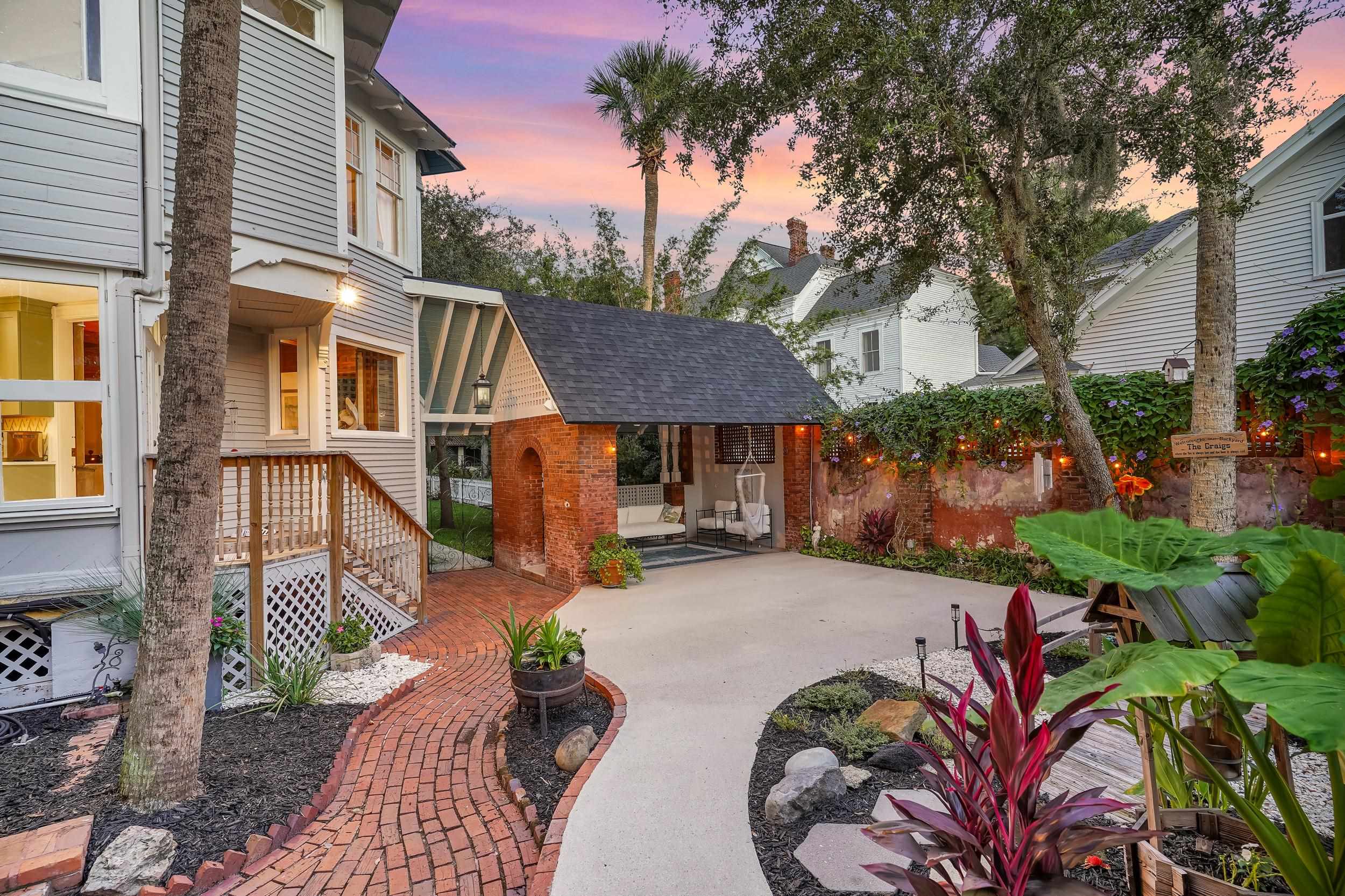 268 St George Street St. Augustine, FL 32084 - Photo 62 of 71 Patio terrace at dusk with a patio area and an outdoor structure