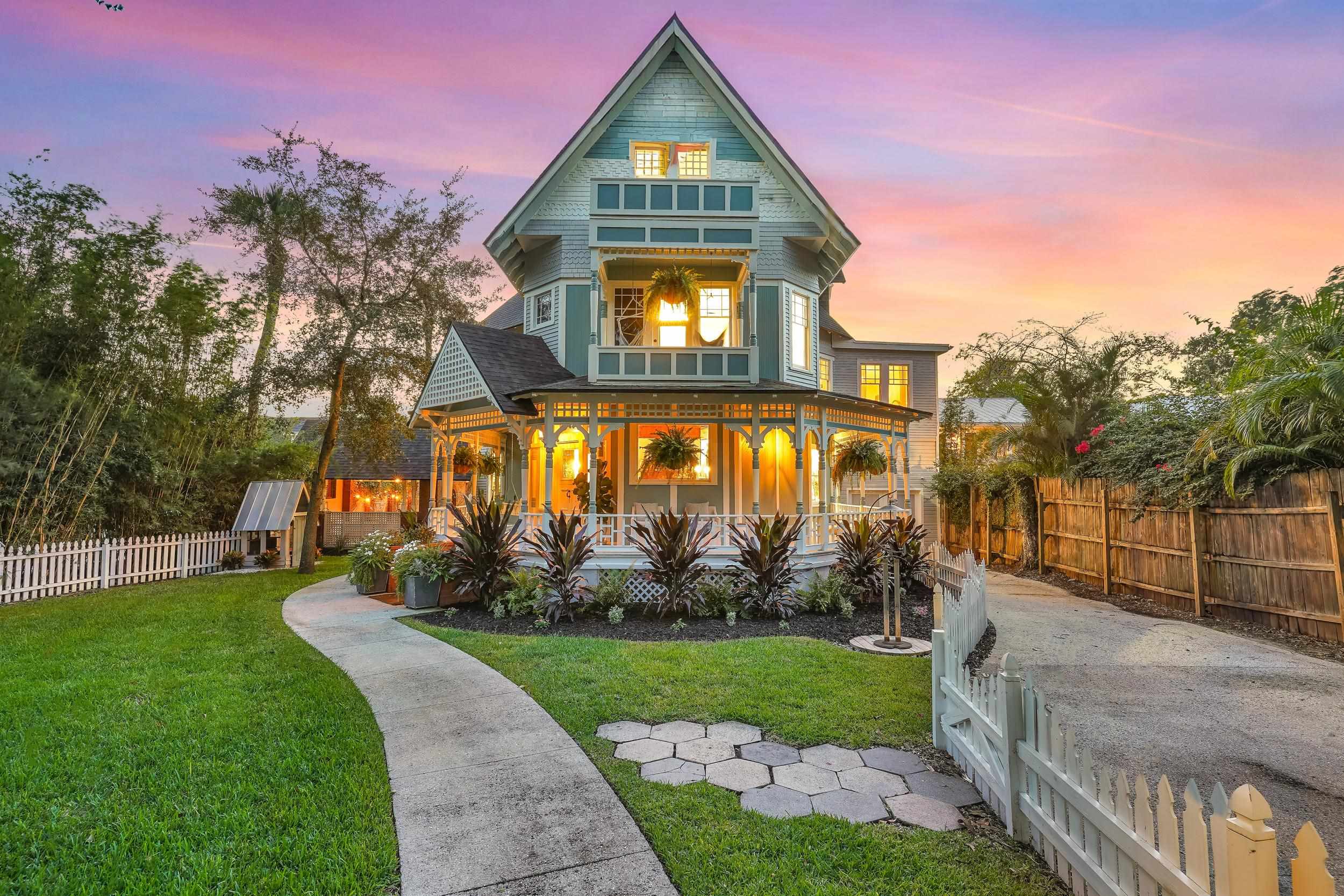 268 St George Street St. Augustine, FL 32084 - Photo 63 of 71 a front view of a house with a yard and potted plants