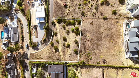 a view of swimming pool with large trees