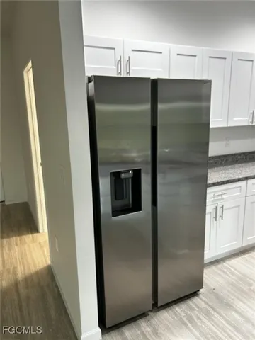 a metallic refrigerator freezer sitting in a kitchen