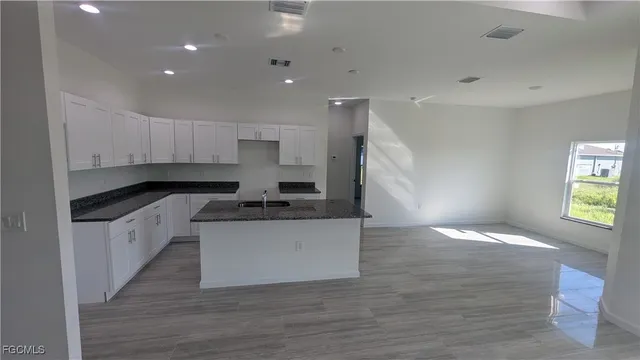 a view of kitchen with sink and wooden floor