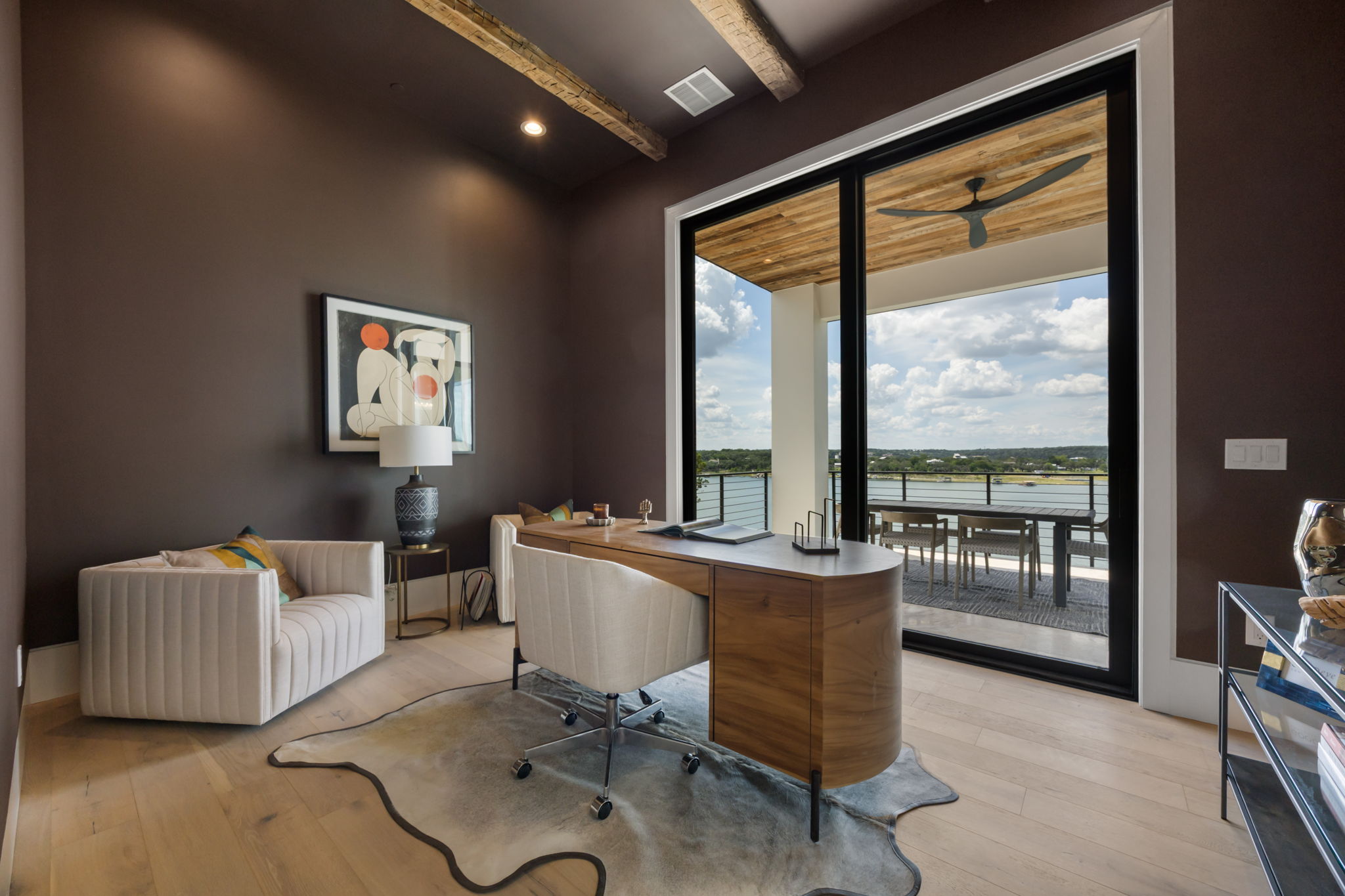 1496 Buffalo Gap Road Lakeway, TX 78734 - Photo 16 of 37 An inviting study with exposed beams offers a stunning waterfront view from its expansive sliding glass doors.