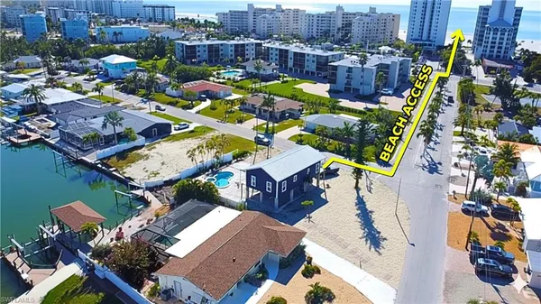 an aerial view of multiple houses with yard