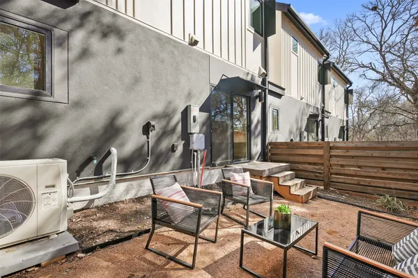 a backyard of a house with barbeque oven table and chairs
