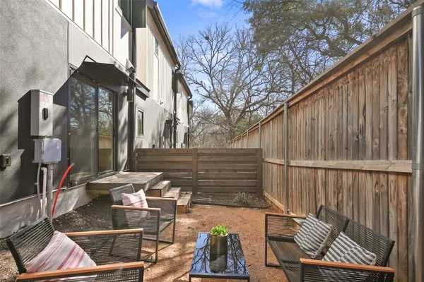 a view of balcony with two chairs and a rug
