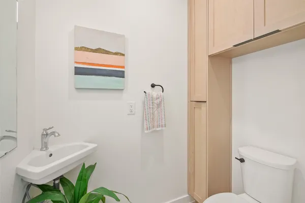a bathroom with a sink a toilet and shower