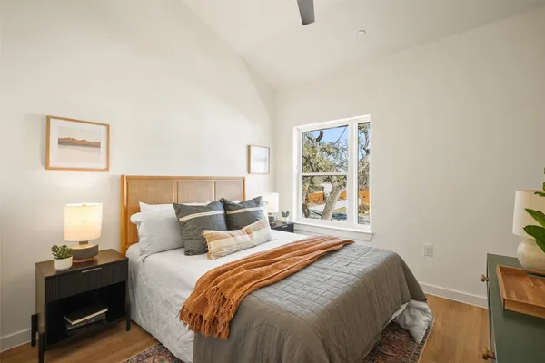 a bedroom with a bed and wooden floor