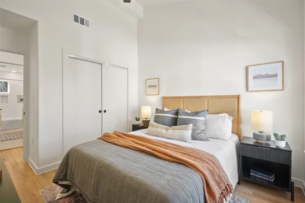 a bedroom with a bed and a lamp
