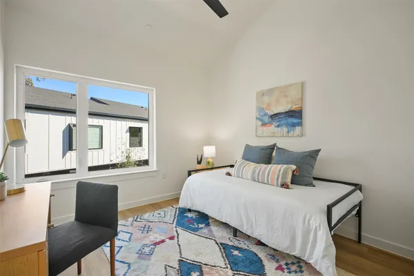 a bedroom with a bed and wooden floor