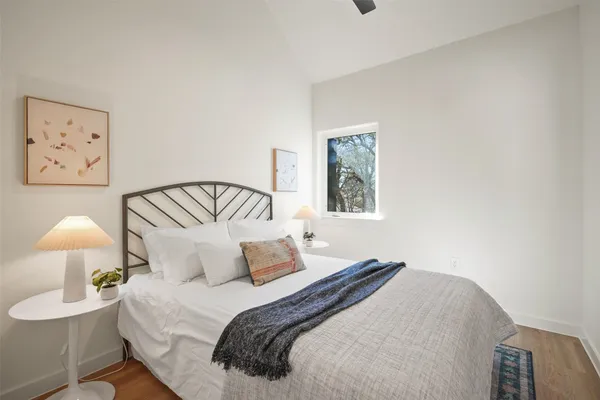 a bedroom with a bed and lamp