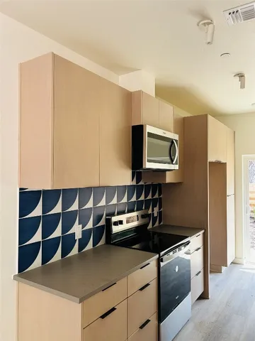 a kitchen with a sink and a stove top oven