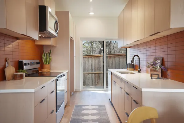 a kitchen with a sink stove and cabinets