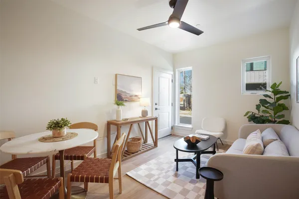 a living room with furniture and a potted plant