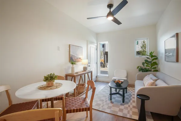 a view of a dining room with furniture and a potted plant
