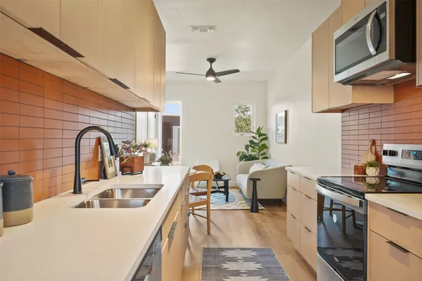 a kitchen with a sink appliances and cabinets