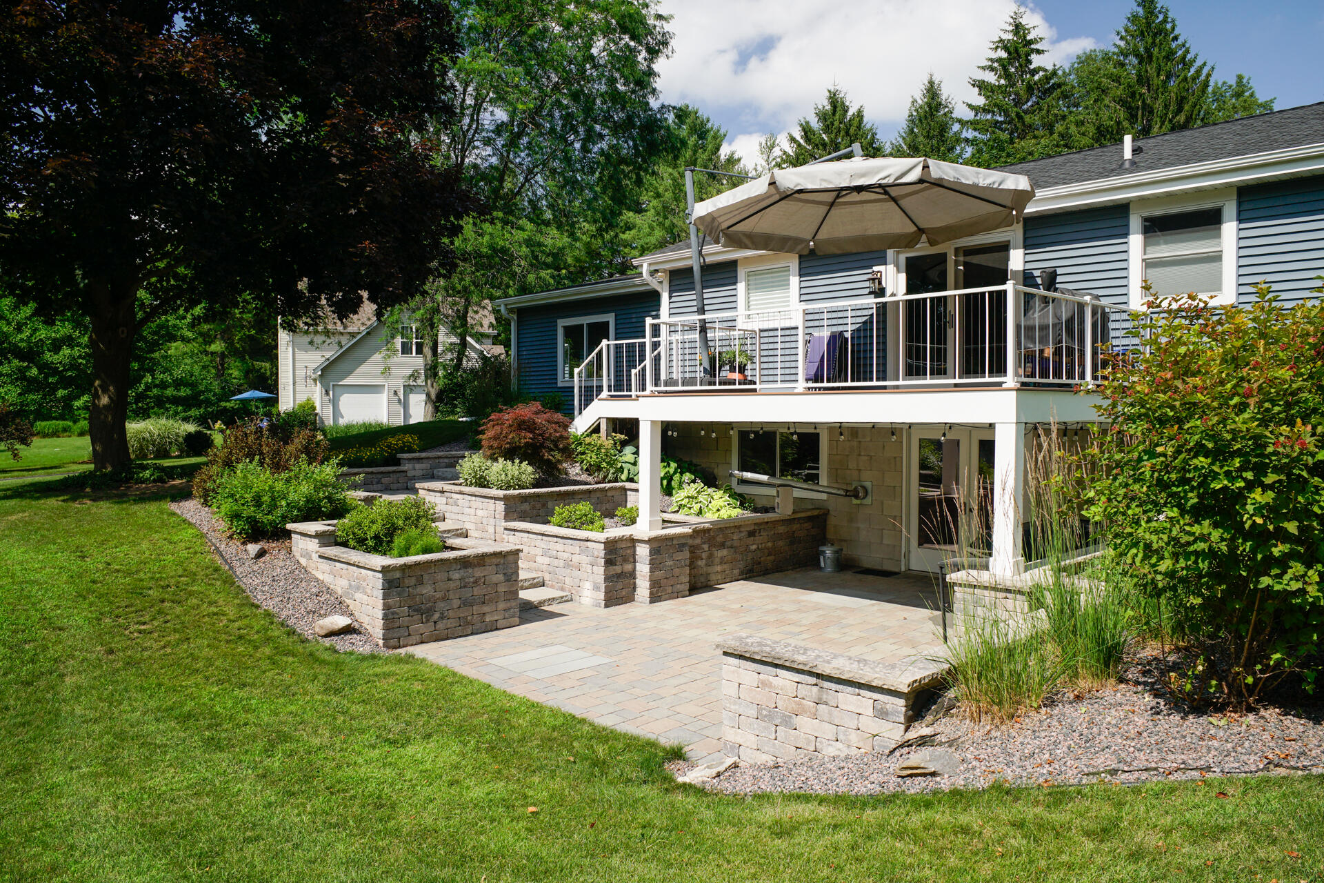 W245N4749 Swan Road Pewaukee, WI 53072 - Photo 27 of 36 Rear deck and landscaped patio