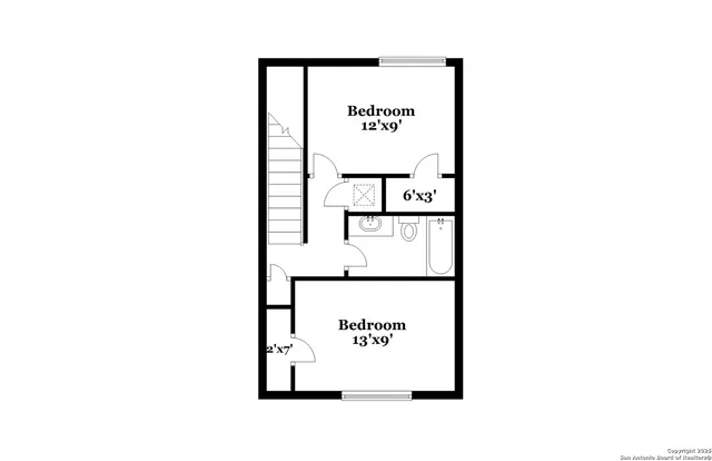 a picture of a bench in front of a wall