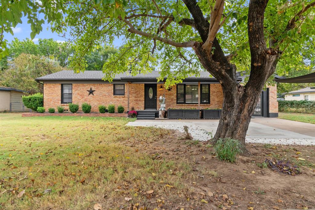 a front view of house with yard and trees
