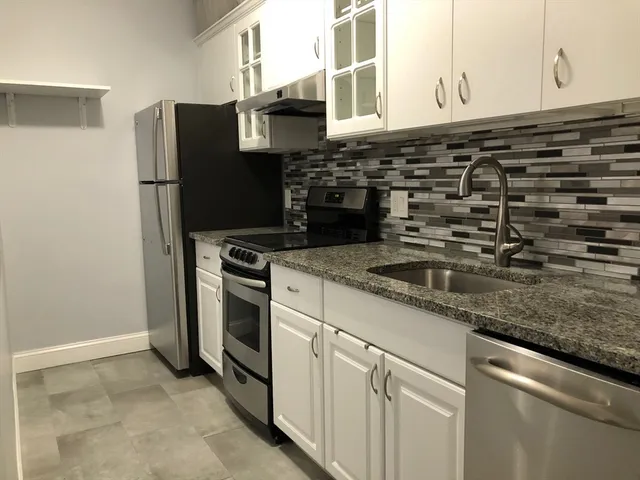 a kitchen with a sink and a refrigerator