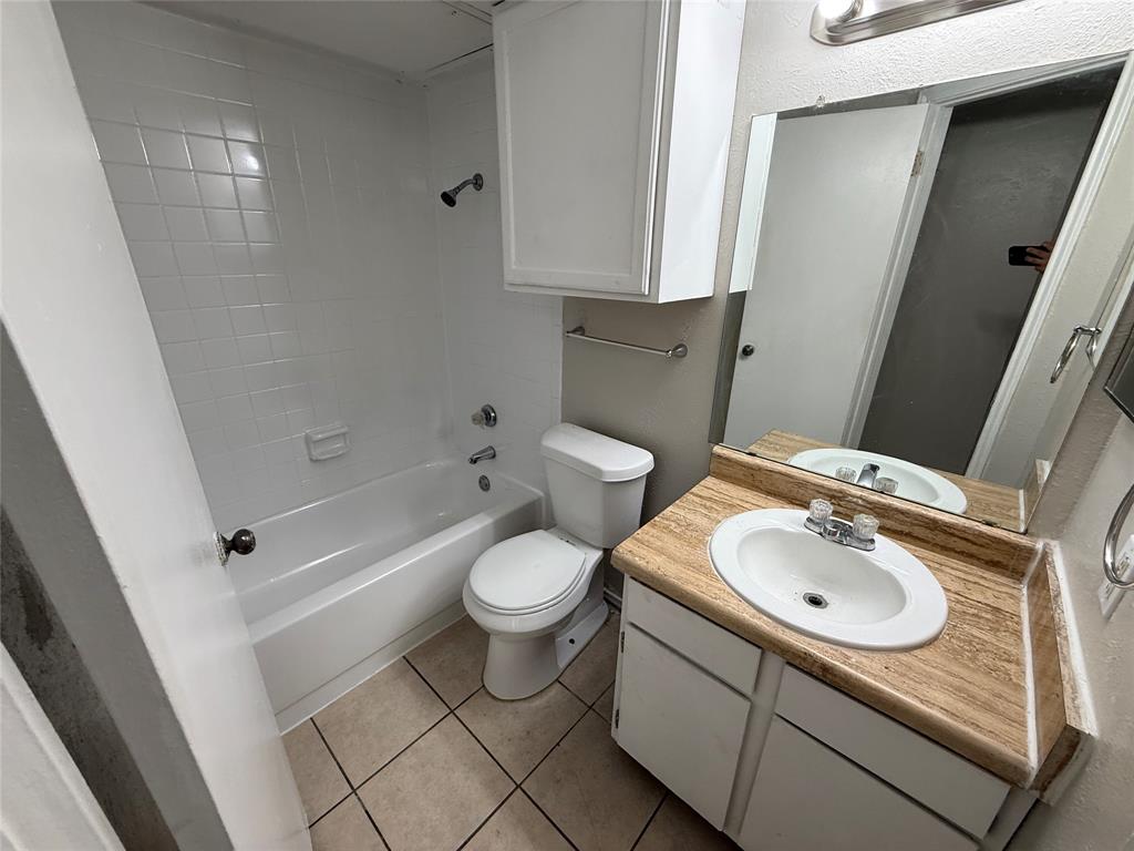 9520 Royal Lane, Unit 214 Dallas, TX 75243 - Photo 9 of 13 a bathroom with a sink toilet and shower