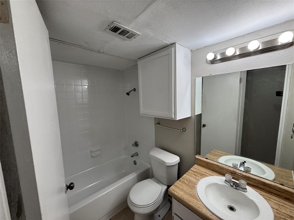 9520 Royal Lane, Unit 214 Dallas, TX 75243 - Photo 10 of 13 a bathroom with a sink a toilet and shower