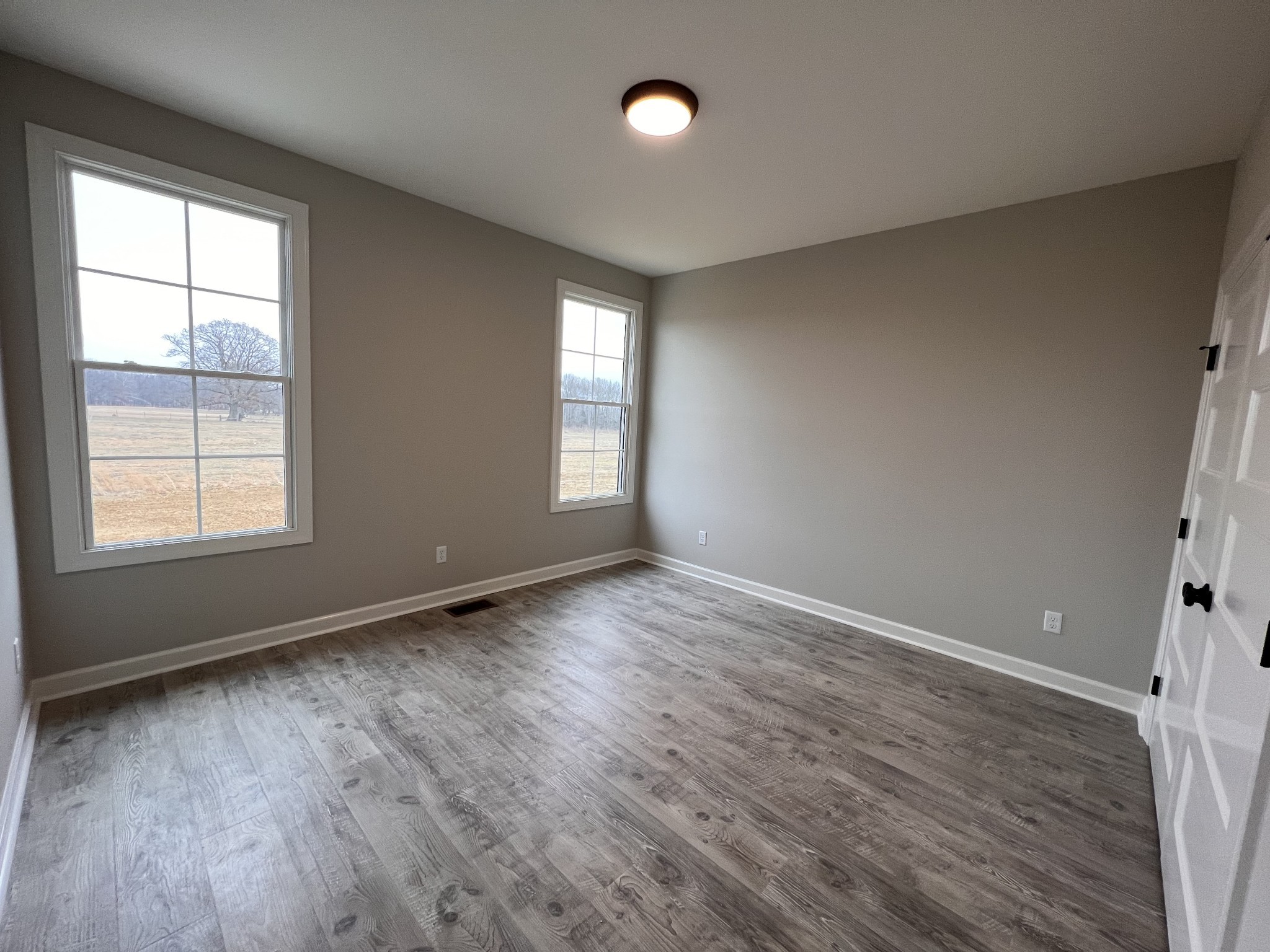 739 Jackson Road, Unit 1 Portland, TN 37148 - Photo 13 of 21 an empty room with wooden floor and windows