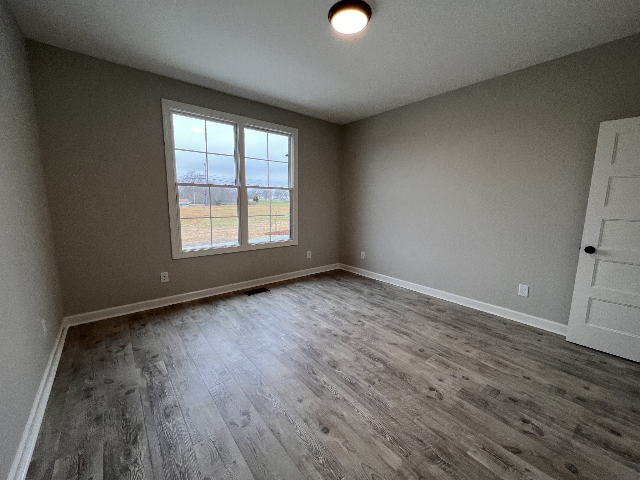 739 Jackson Road, Unit 1 Portland, TN 37148 - Photo 14 of 21 an empty room with wooden floor and windows