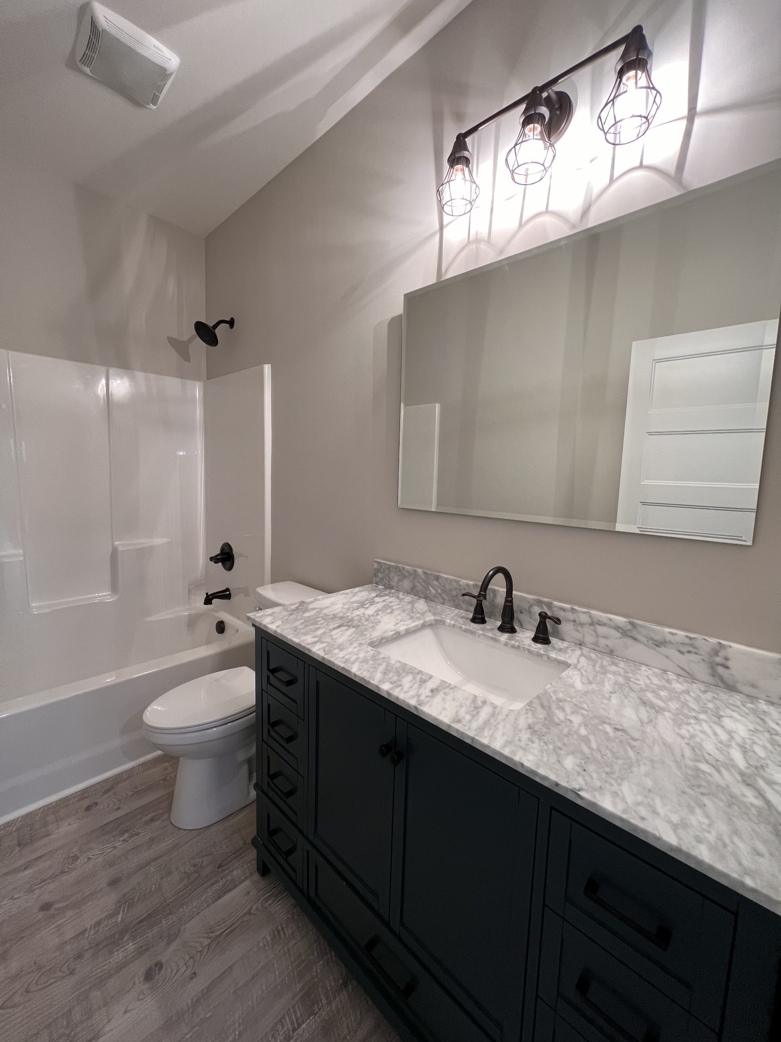 739 Jackson Road, Unit 1 Portland, TN 37148 - Photo 15 of 21 a bathroom with a granite countertop bathtub sink vanity mirror and toilet