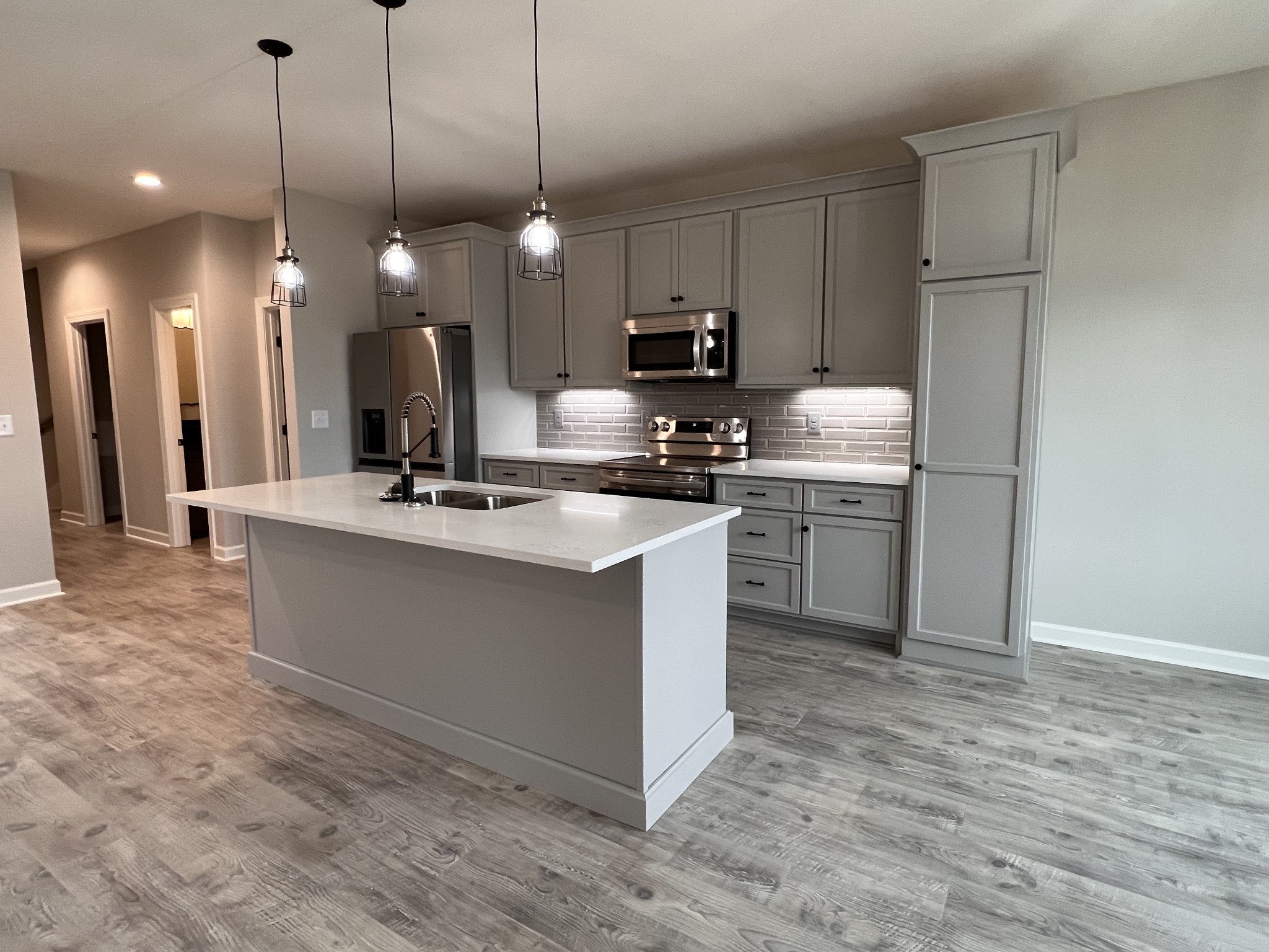 739 Jackson Road, Unit 1 Portland, TN 37148 - Photo 5 of 21 a kitchen with kitchen island a sink stainless steel appliances and wooden floor