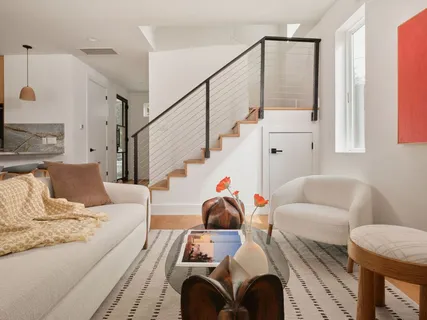 a living room with furniture a window and a lamp