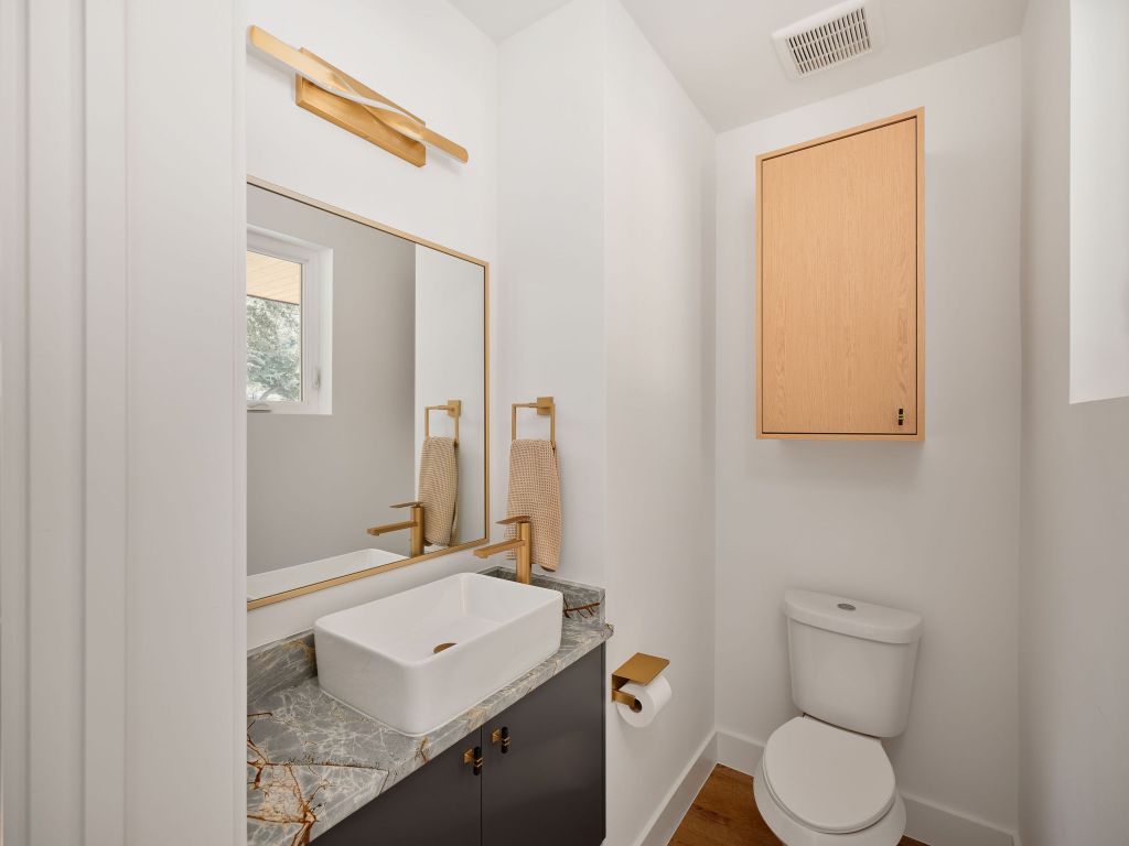 3307 Kay Street, Unit 1 Austin, TX 78702 - Photo 16 of 40 a bathroom with a toilet sink and mirror