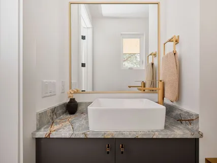 a bathroom with a toilet sink and mirror